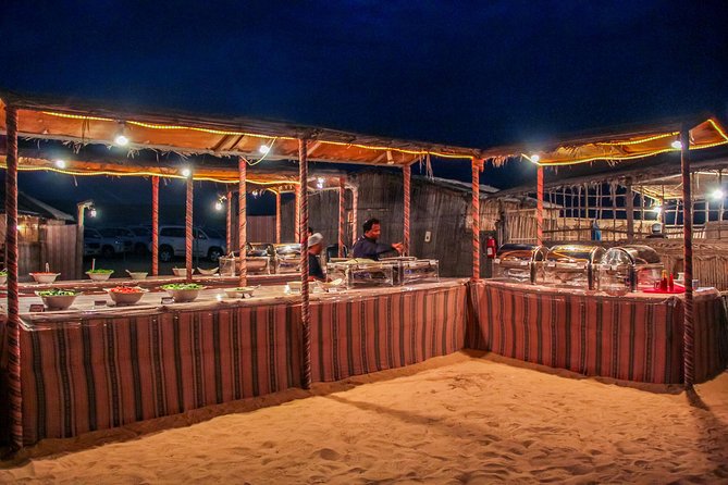 Abu Dhabi Evening Desert Safari with BBQ Dinner and all Camp Activities - Sunset and torch-lit camp: where the mood changes