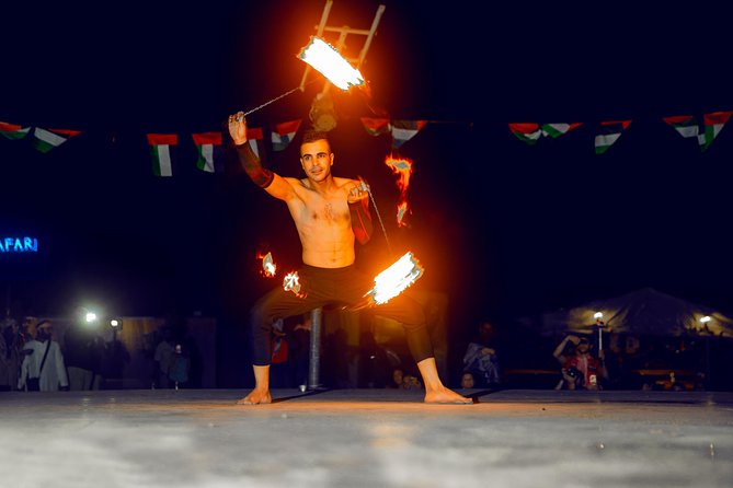 Desert Safari Dubai with Dune Bashing, Sandboarding, Camel Ride, 5 Shows, Dinner - Shows and BBQ Dinner: fire on stage and an international buffet