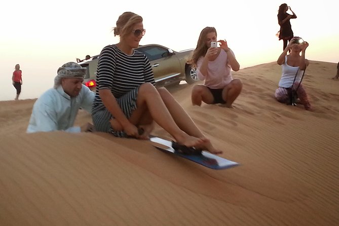 Desert Safari Tour - FULL PROGRAM with Dinner Show and more... - Stop 2 at Al Madam: Deeper Dunes, Sunset Photos, and Sandboarding