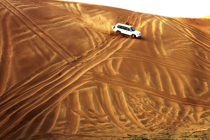 Doha Desert Safari Dune Bashing Camel Ride Sandboarding - Inland Sea Beach: where the dunes and turquoise water meet