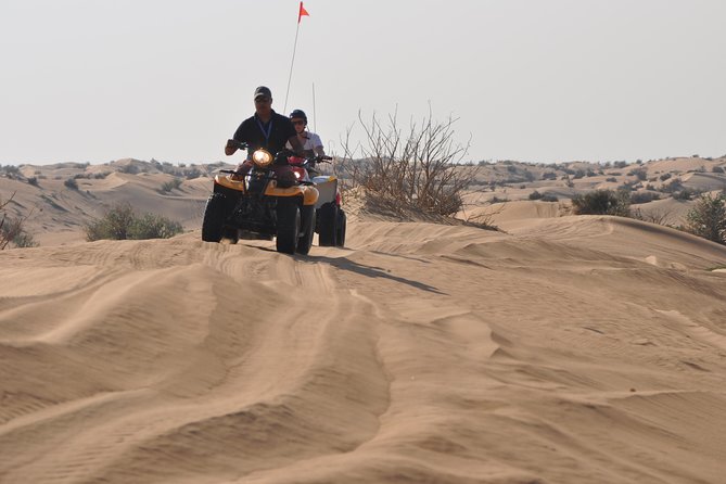 Dubai Desert Afternoon Quad Safari with Camel Ride, BBQ Dinner and Belly Dancing - Bedouin-Style Camp by Torchlight: Coffee, Dates, Henna, and Optional Shisha
