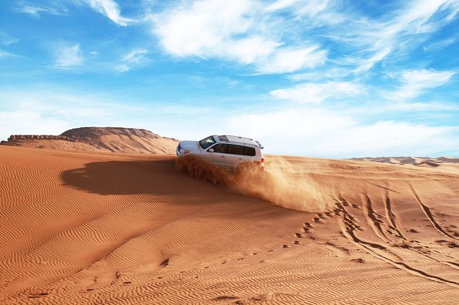 Dubai Desert Bespoke: Red Dunes Safari, Camel Ride & BBQ Options - Desert meeting point: Tire prep, safety checks, and optional quad time