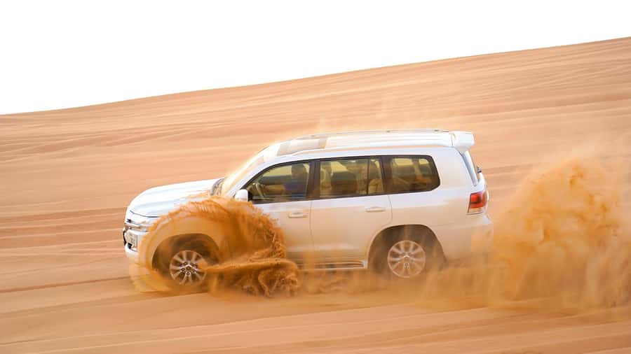 Dubai: Desert Safari, Camel Ride, Sandboarding, Quad Bike - Sandboarding: like snowboarding, with sand physics