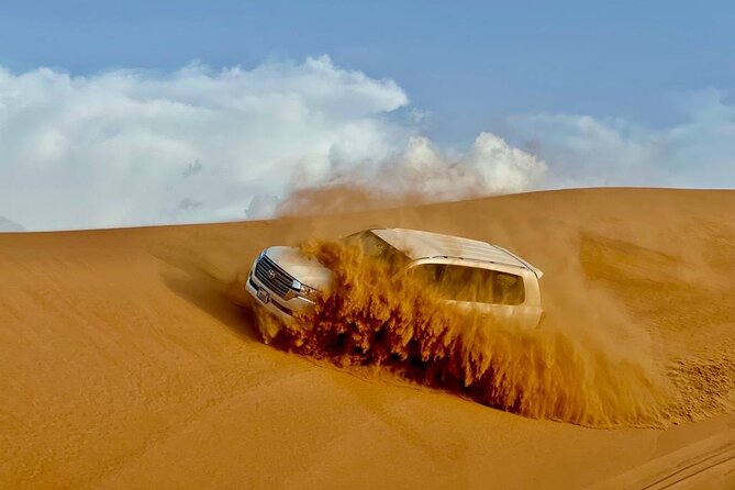 Dubai Desert Safari: Dune Bashing, Camel Ride, Sandsurf & 5<em> BBQ – Key Highlights Worth Your Attention’ /></p>
<ul>
<li><strong>Longer dune-bashing time</strong> for more real sand-time, not just a quick spin</li>
<li><strong>Sandboarding + sunset photo stop</strong> so you get both action and that golden-hour look</li>
<li><strong>Camel ride and camel feeding</strong> around the camp area for a hands-on, low-pressure add-on</li>
<li><strong>Falcon expert time plus Arabian attire + henna</strong> for easy, memorable photos</li>
<li><strong>Tanoura, fire show, belly dance, and Ladies Khaliji dance</strong> in one evening schedule</li>
<li><strong>5<em> style BBQ buffet with vegetarian and non-vegetarian options</strong> plus sweets and gahwa</li>
</ul>
<h2 id="desert-dunes-with-a-4x4-pickup-and-a-real-camp">Desert Dunes With a 4×4 Pickup and a Real Camp</h2>
<p><img width="669" height="446" decoding="async" src=
