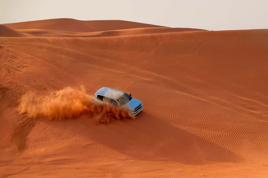 Dubai: Desert Safari, Quad Bike, Sandboarding, Camels & BBQ - From Hotel Pickup to the Lehbab Red Dunes