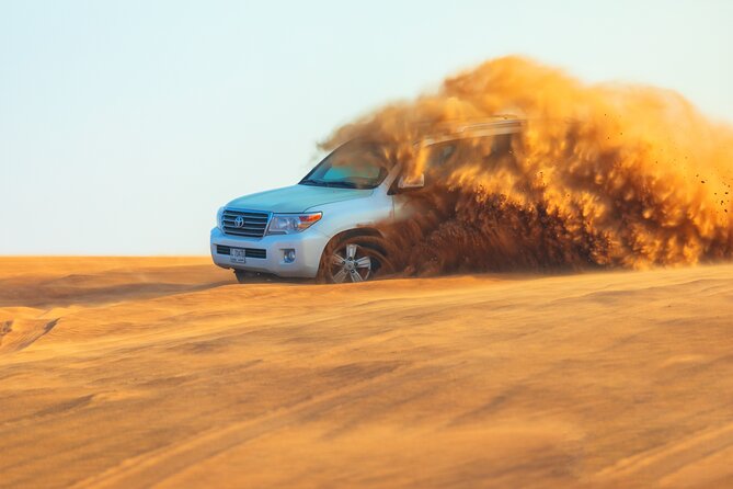 Dubai Evening Desert Safari With Transfers Dune Bashing & Dinner - From your hotel to the Lahbab dunes in a 4x4 SUV