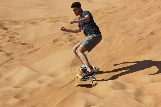 Dubai: Extreme Red Dune Buggy Desert Safari Adventure - Sandboarding on the highest dune: the payoff moment