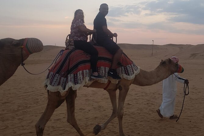 Dubai: Unique SUNSET 4WD Red Dunes Safari - Sandboarding at sunset: the best kind of souvenir