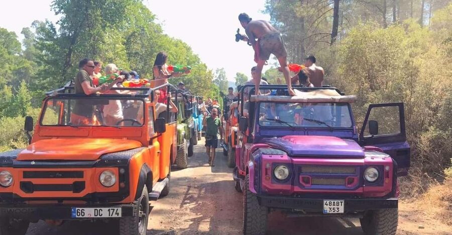 Icmeler Jeep Safari, Lunch, Water Fight, Colour & Foam Party - Jesus Beach: A Natural Sand Wall Walk Through Deeper Water