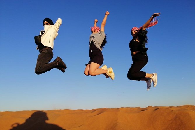 Premium Red Dune Safari, Sandboarding, Camel Ride, 5<em> BBQ Dinner – Sunset Over the Red Dunes: Photos and Timing That Actually Matter’ /><br />
This tour is built around the evening mood. You’ll see the <strong>sunset over the towering red dunes</strong>, and that’s not just a scenic add-on—it’s when the desert looks its best on camera and with your own eyes.</p>
<p><p>What you’ll want to manage is timing. The drive out happens in the afternoon, but the big picture is: you’re not stuck on sand all night waiting. The evening is staged so the camp activities and the show line up with the best light and the dinner moment.</p>
</p>
<p><p>If you care about photos, the tour’s structure helps. Expect photo chances during the desert segments, and you’ll be in position at the camp for the sunset look. Guides are also praised for stopping for pictures during dune bashing, which makes it easier to capture the dunes without constantly asking the group to pause.</p>
</p>
<h2 id="5-bbq-dinner-plus-fire-belly-dancing-and-tanura">5</em> BBQ Dinner Plus Fire, Belly Dancing, and Tanura</h2>
<p><img width="669" height="446" decoding="async" src=
