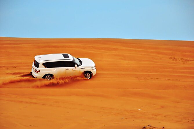 Private Evening Desert Safari: Sandboarding Camel Ride BBQ Dinner - Photos and extras: where guides like Jigaro help you get the shots