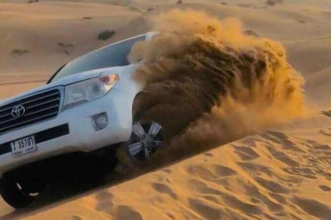 Quad Bike Dubai Desert Safari with BBQ Dinner Sandboard and Show - Lahbab Desert stop: ATV quad biking and red-dune sunset photos