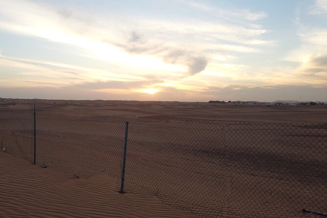 Shared Desert Safari Tour Dubai with Dinner Included - Sunset from a high dune: short time, big payoff for photos