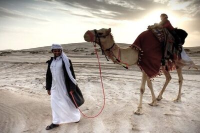 Thrilling 4-Hour Dune Bashing & Camel Ride Safari to Inland Sea - Pickup, stadium glimpses, and why the ride between stops matters